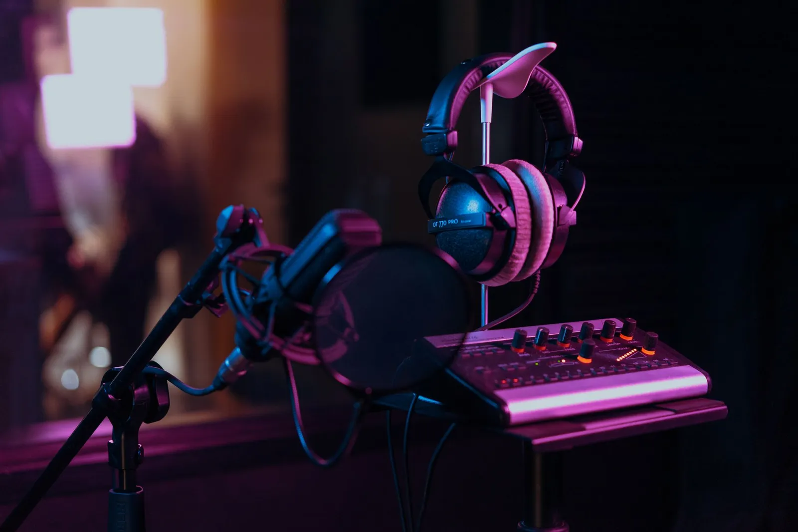 High quality audio recording studio setup with a microphone, headphones, and mix